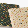 Two patterned notebooks with festive designs on a white background