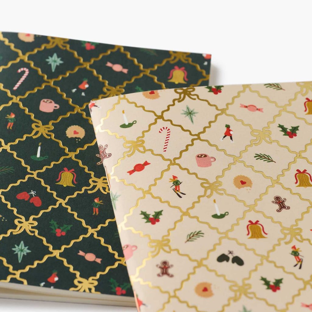 Two patterned notebooks with festive designs on a white background