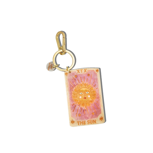 Keychain with tarot card design featuring a sun illustration on a white background