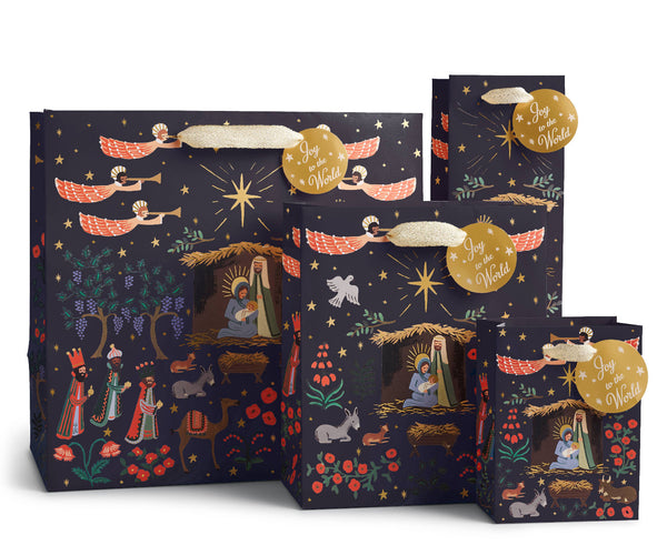 Set of Christmas-themed gift bags with nativity scene design on a dark background.