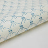 White fabric with blue floral pattern on a white background