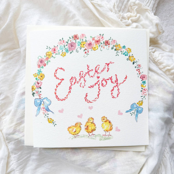 Easter-themed card with chicks, flowers, and 'Easter Joy' text on a white fabric background.
