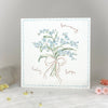 Greeting card with floral design and text on a white surface