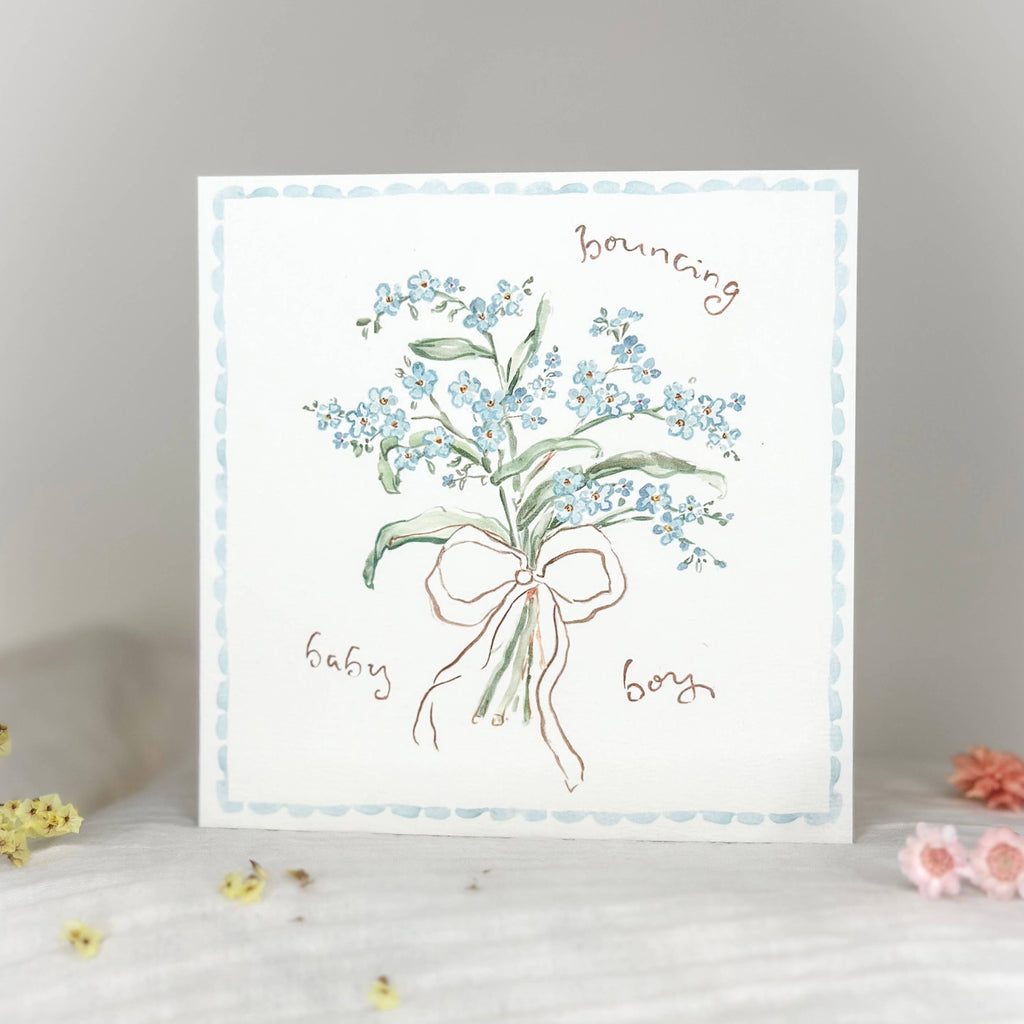 Greeting card with floral design and text on a white surface