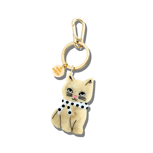 Cat-shaped keychain with gold ring on a white background