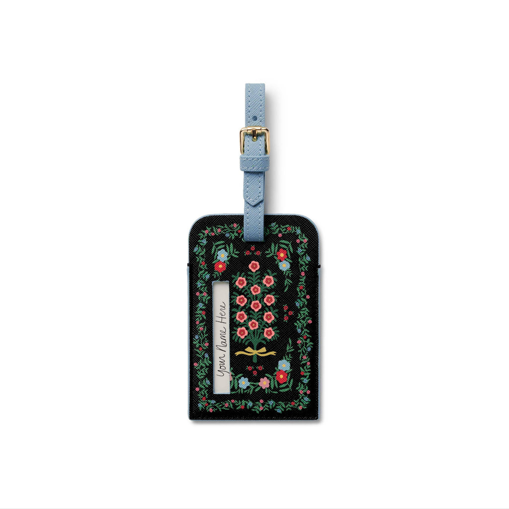 Luggage tag with floral design and text on a white background