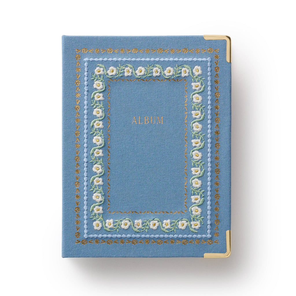 Blue album with floral design on a white background