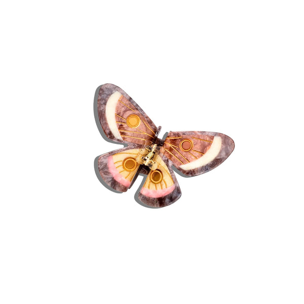 Butterfly-shaped object with pink and orange colors on a white background