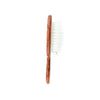 Wooden hairbrush with white bristles on a white background