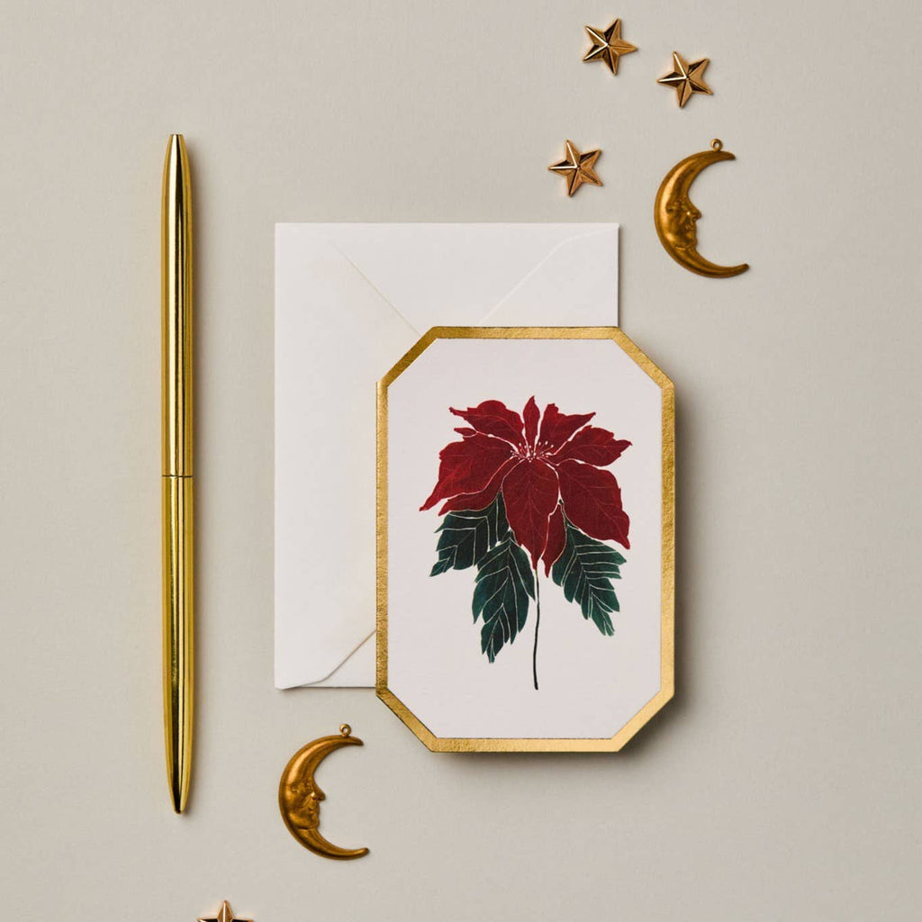 Decorative card with red flower design, gold pen, and decorative elements on a beige background