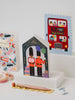 Two birthday cards with illustrations of London-themed designs on a white surface.