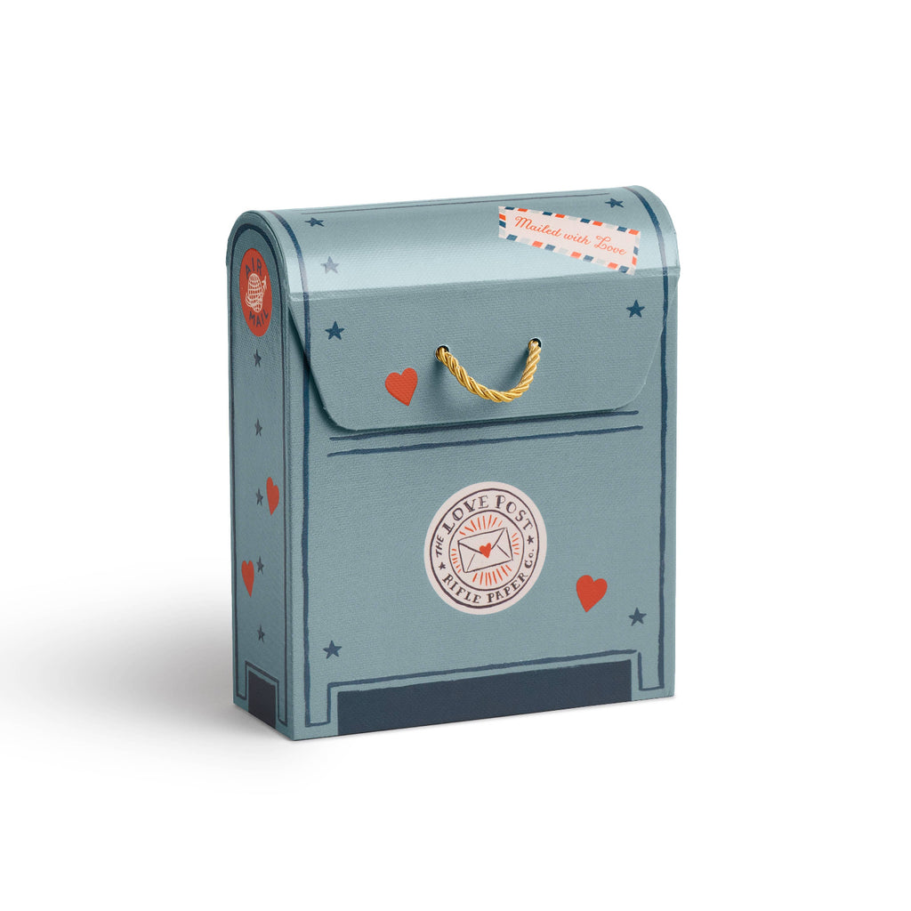 Decorative mailbox with heart and star designs on a white background