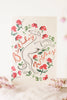 Greeting card with a dog illustration and floral elements on a light background