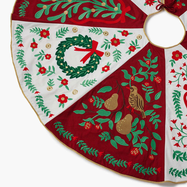Decorative Christmas tree skirt with festive patterns on a white background