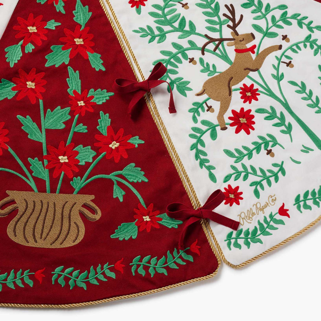Christmas-themed table runner with floral and reindeer designs on a white background