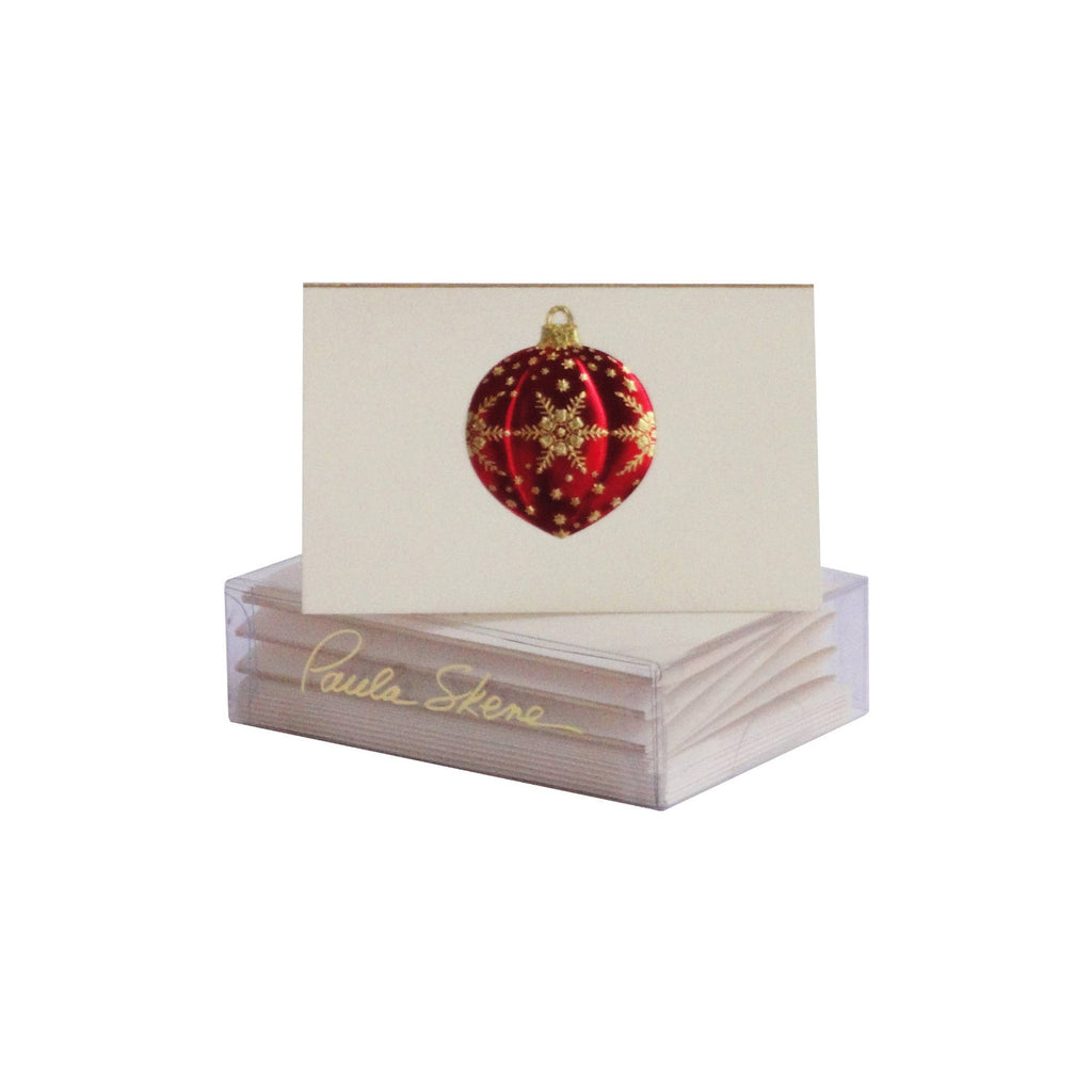 Stack of cards with a red and gold ornament design on a white background