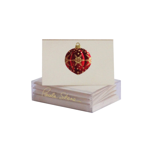 Stack of cards with a red and gold ornament design on a white background