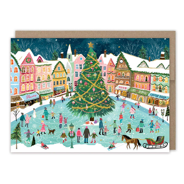 Christmas card with a snowy village scene, Christmas tree, and people skating.