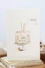 Greeting card with a cake illustration and floral details on a white background