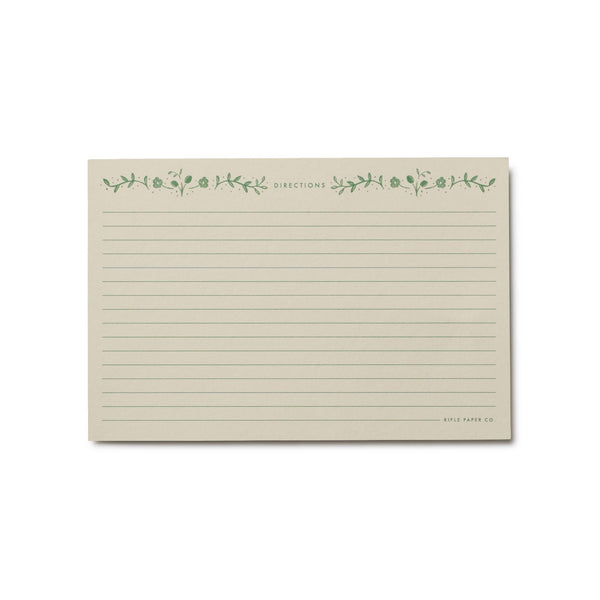 Note card with green floral design and text on a white background