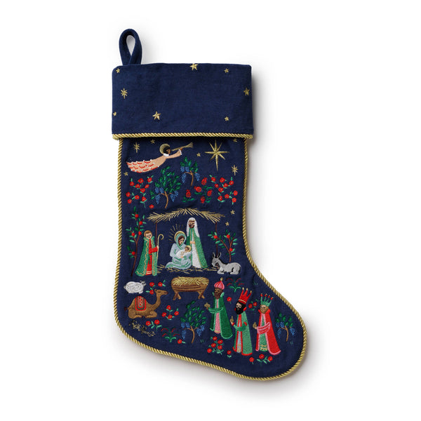 Navy blue Christmas stocking with nativity scene design on a white background