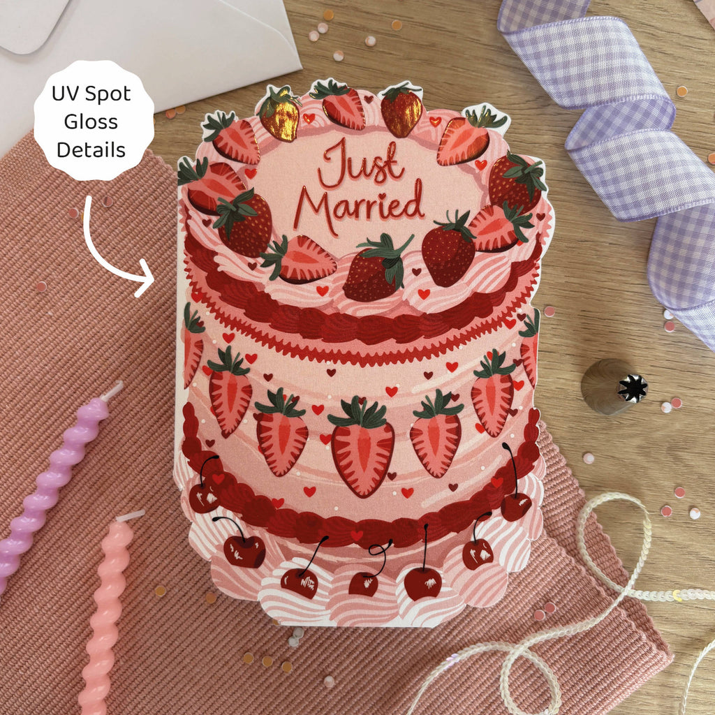 Illustration of a 'Just Married' cake with strawberry decorations on a wooden surface.