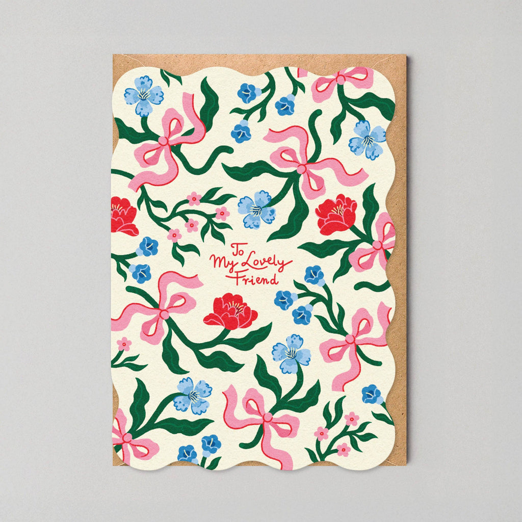 Greeting card with floral and bow pattern on a gray background