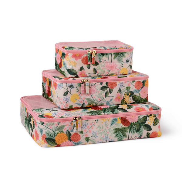 Set of three floral-patterned luggage boxes on a white background