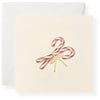 Greeting card with candy canes and a bow on a white background