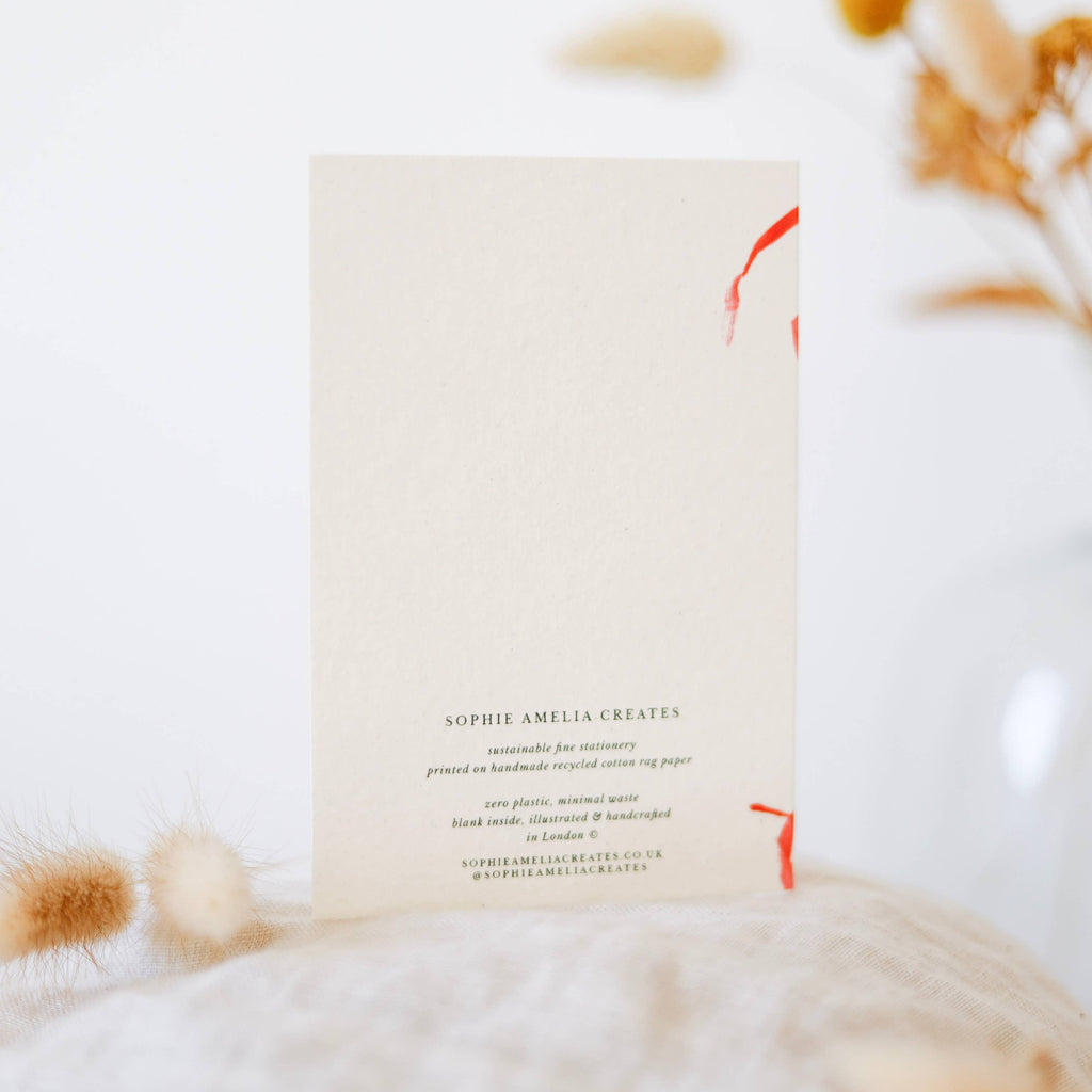 Book with a cat lying on a white blanket