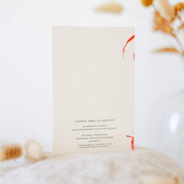 Book with a cat lying on a white blanket