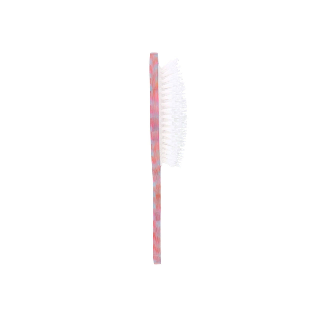 White toothbrush with red bristle head on a white background