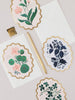 Floral stationery items including cards and an envelope on a light background