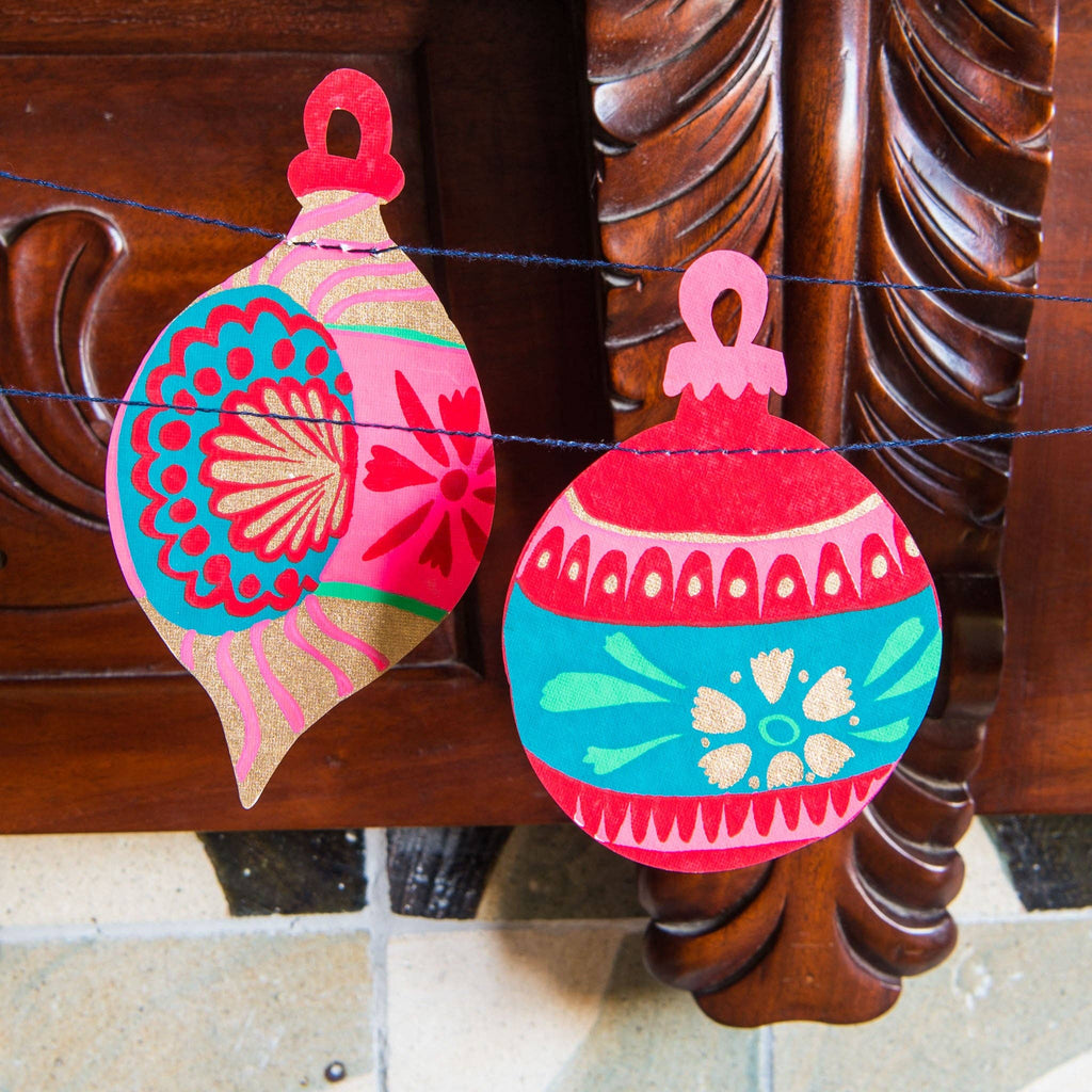 Decorative Christmas ornaments hanging on a wooden surface
