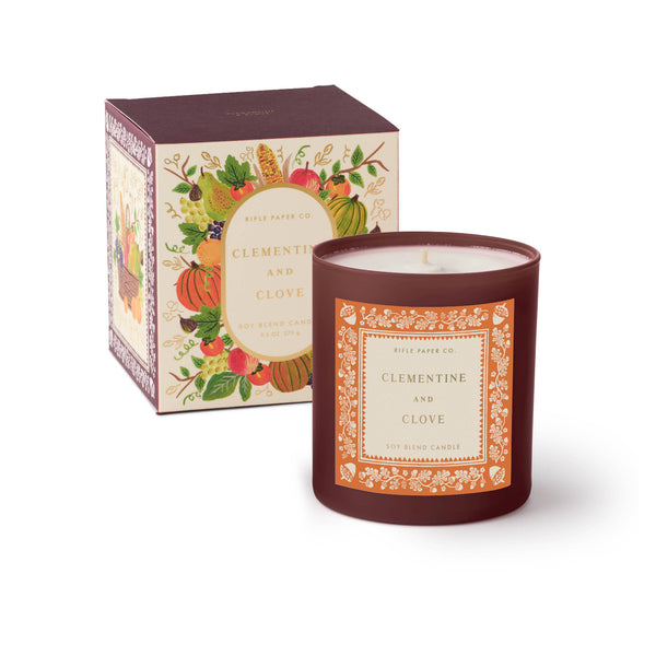 Candle with decorative packaging on a white background