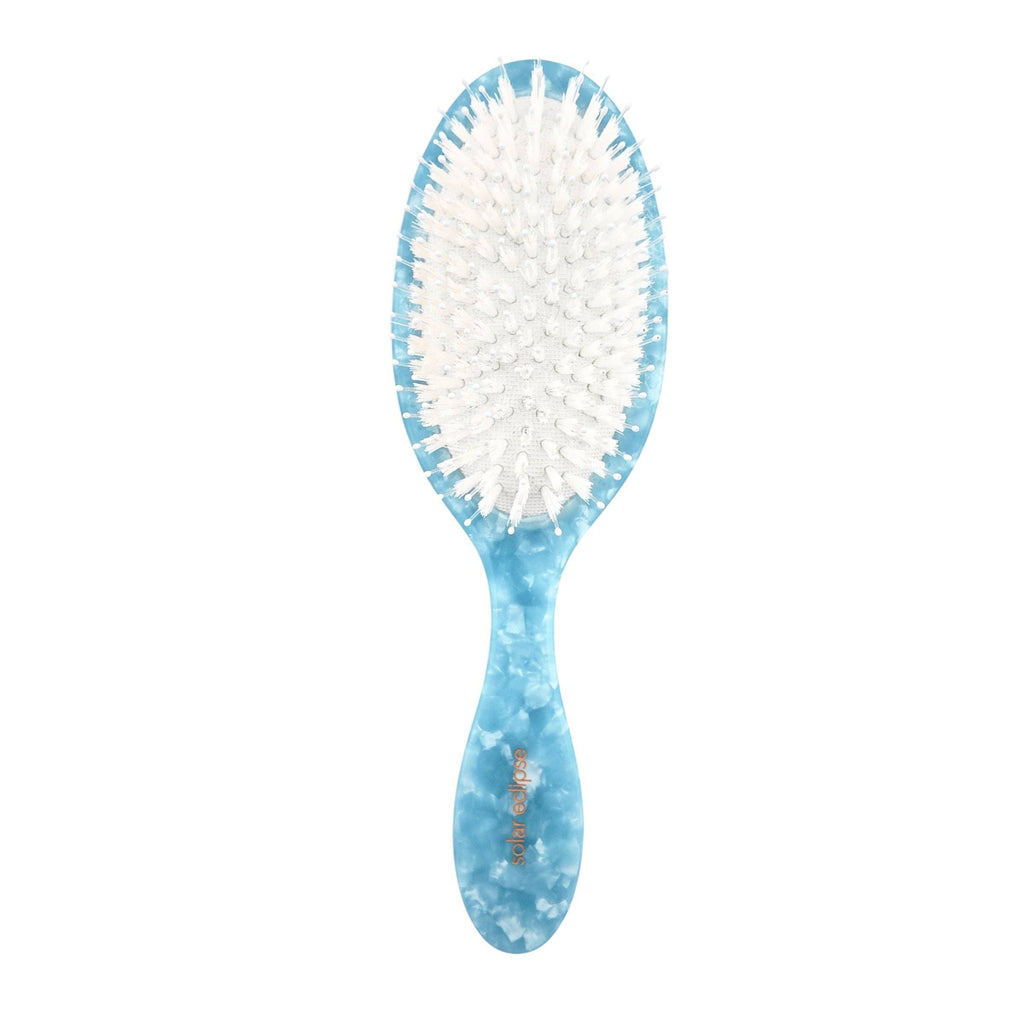 Blue and white hairbrush on a white background