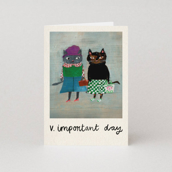 Greeting card with two cartoon cats in colorful clothing on a gray background