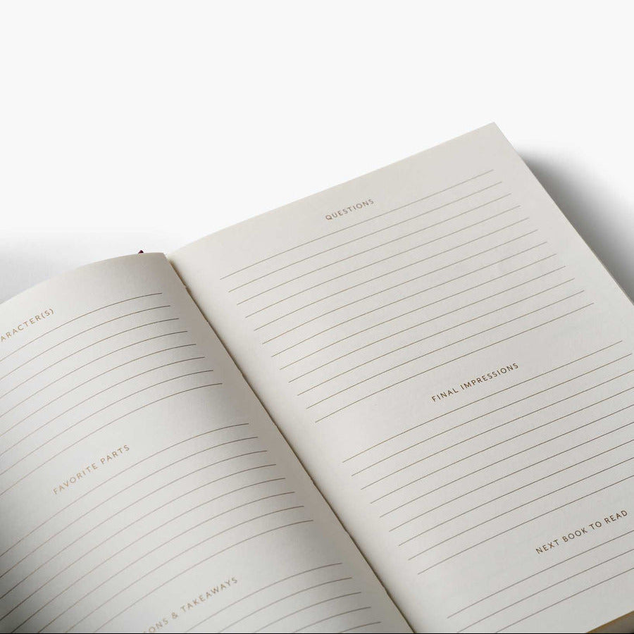Open notebook with lined pages and text on a white background