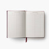 Open notebook with a list titled 'Books to Read' on a white background