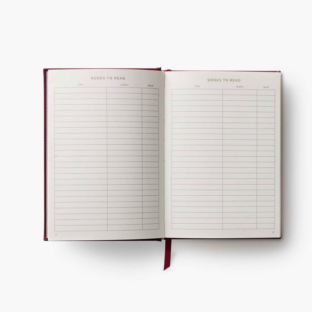 Open notebook with a list titled 'Books to Read' on a white background