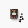 Jigsaw puzzle box with a Christmas-themed design on a white background