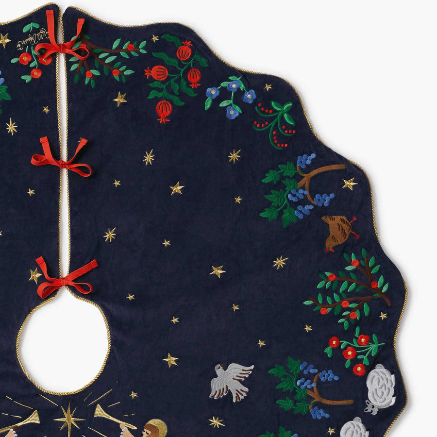 Embroidered tree skirt with celestial design on a white background