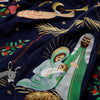 Embroidered nativity scene with Mary, Joseph, and baby Jesus on a dark blue fabric.