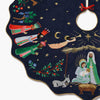 Decorative Christmas tree skirt with nativity scene design on a dark blue background.