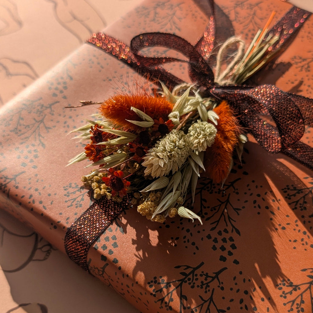Gift wrapped in brown paper with decorative elements on a matching background